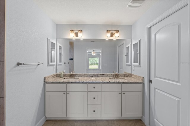 bathroom with tile patterned floors, ceiling fan, and vanity