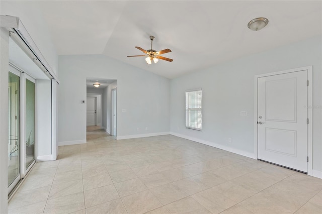 spare room with ceiling fan, light tile patterned floors, and vaulted ceiling