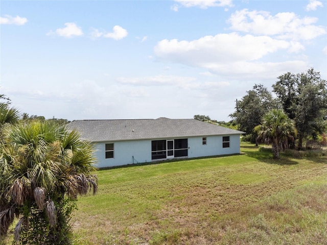 rear view of house with a yard