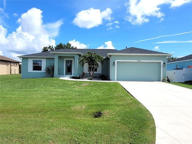 ranch-style house featuring a garage and a front yard