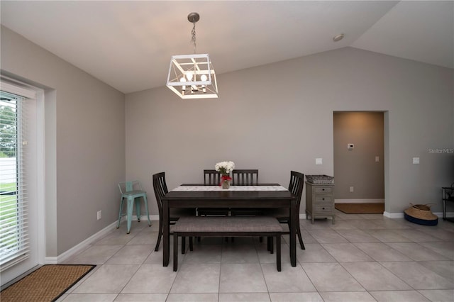 dining area featuring a notable chandelier, light tile patterned flooring, and vaulted ceiling