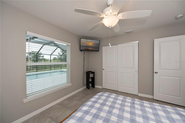 unfurnished bedroom featuring ceiling fan, a closet, and light tile patterned floors