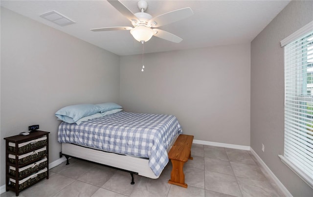 tiled bedroom with ceiling fan