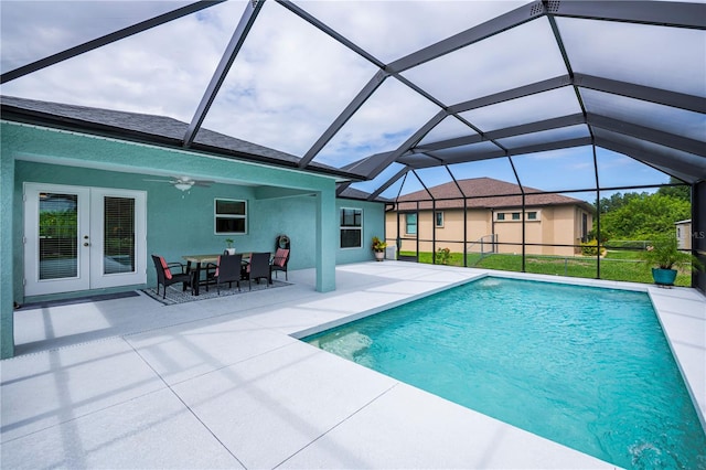 view of swimming pool featuring ceiling fan, a patio area, a lanai, and french doors