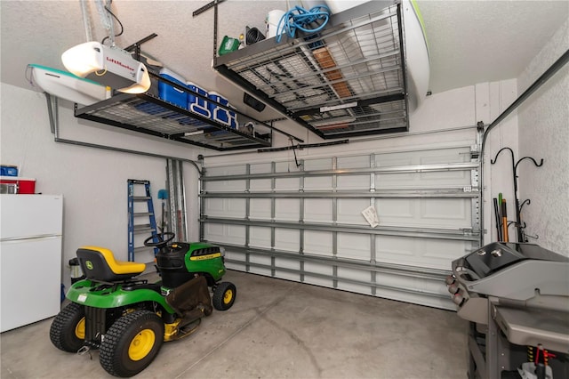 garage with white refrigerator and a garage door opener