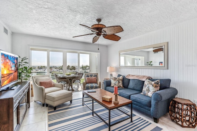 tiled living room featuring ceiling fan