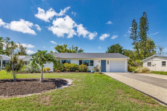 ranch-style house with a garage and a front yard