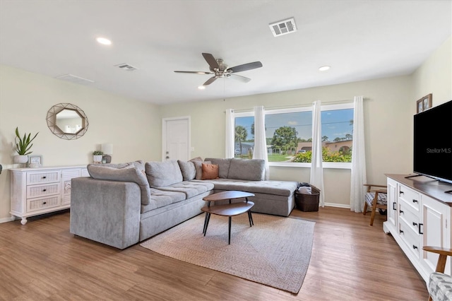 living room with ceiling fan and hardwood / wood-style floors