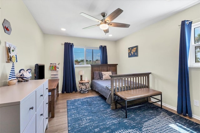 bedroom featuring ceiling fan and light hardwood / wood-style flooring