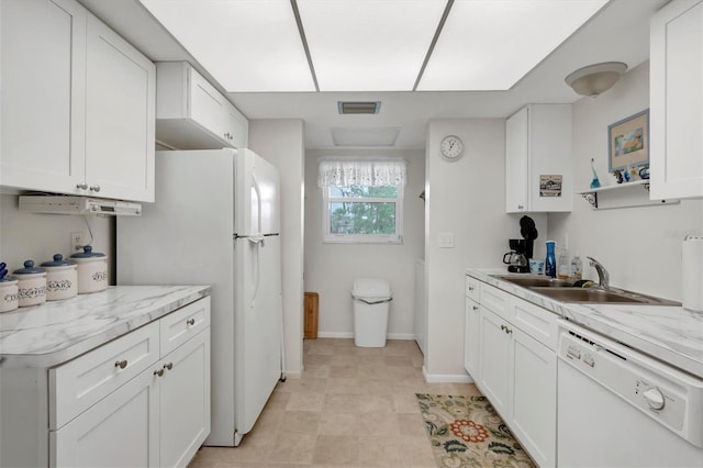 kitchen with white cabinetry, light stone countertops, sink, and white appliances