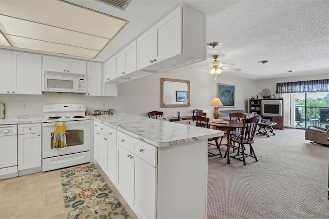 kitchen with white cabinetry, white appliances, and kitchen peninsula