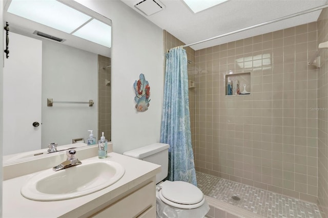 bathroom featuring vanity, curtained shower, and toilet