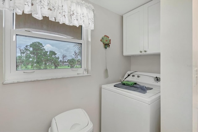 laundry area with cabinets and washer / dryer