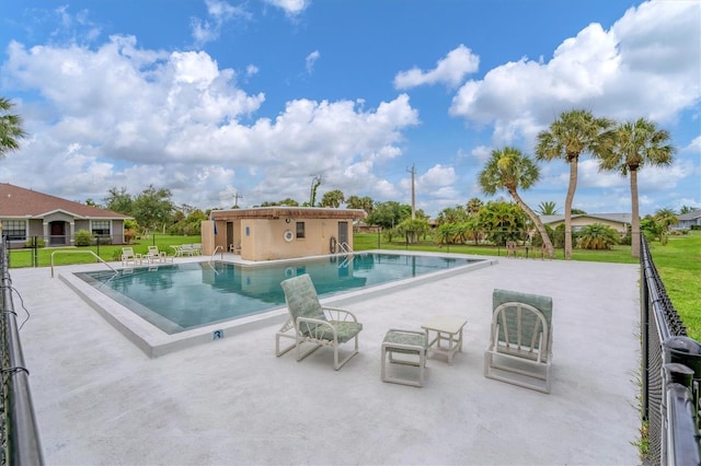 view of pool featuring a yard and a patio area