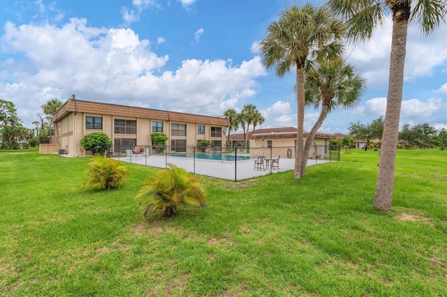 view of pool with a yard