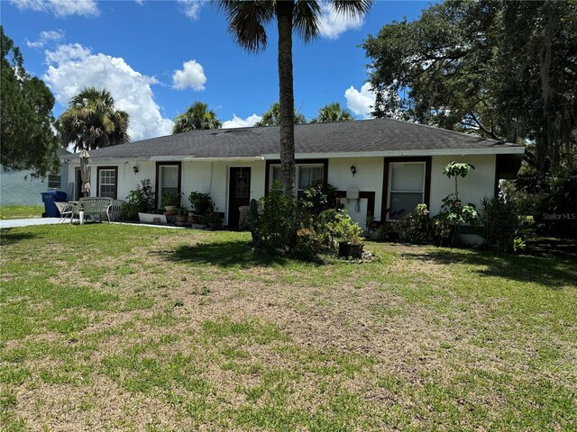 ranch-style home featuring a front yard