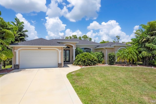 single story home featuring a garage and a front yard