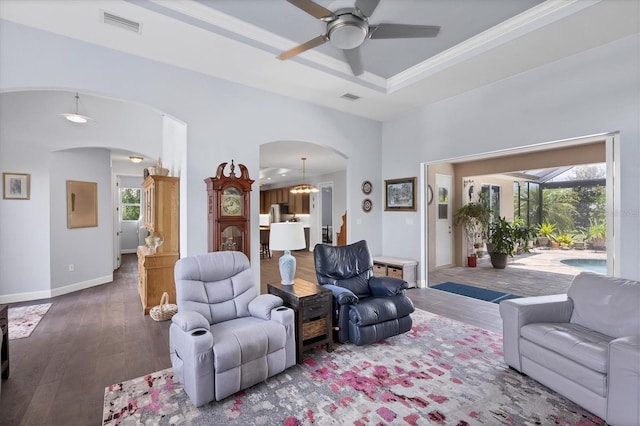 living room featuring plenty of natural light, dark hardwood / wood-style flooring, and ceiling fan