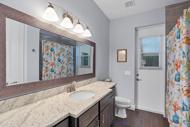 bathroom featuring toilet and vanity