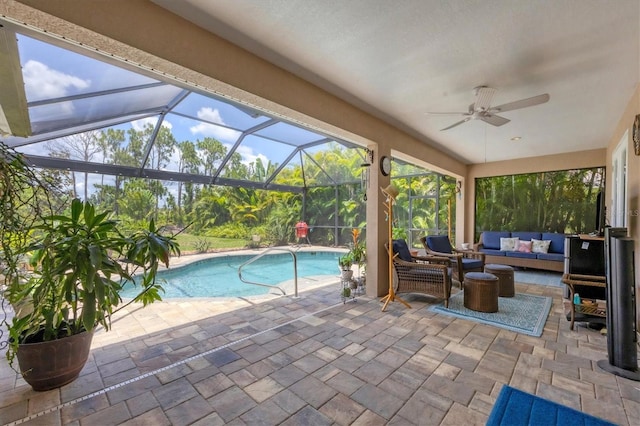 view of pool featuring a patio area, an outdoor hangout area, ceiling fan, and glass enclosure