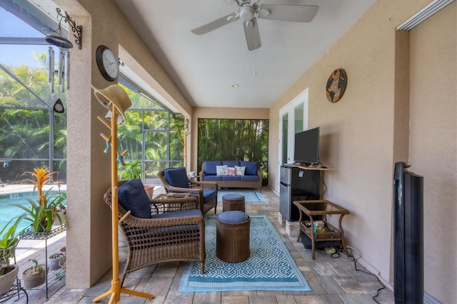 sunroom / solarium featuring ceiling fan