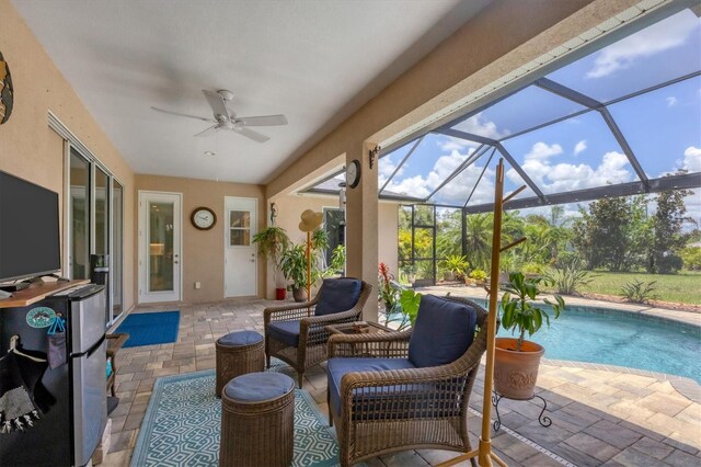 sunroom / solarium featuring ceiling fan