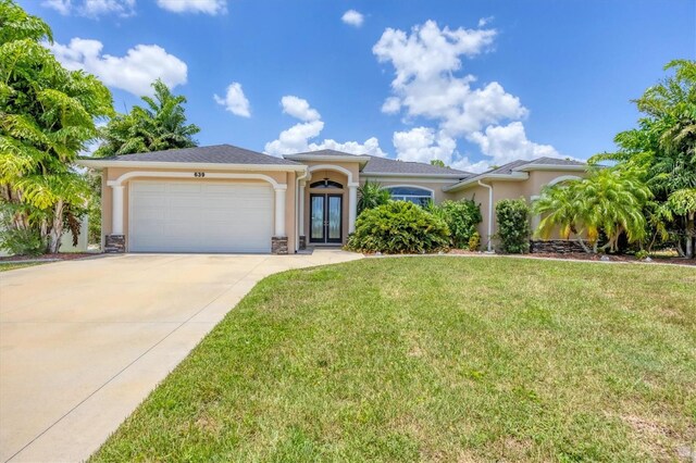 view of front of home featuring a garage and a front yard