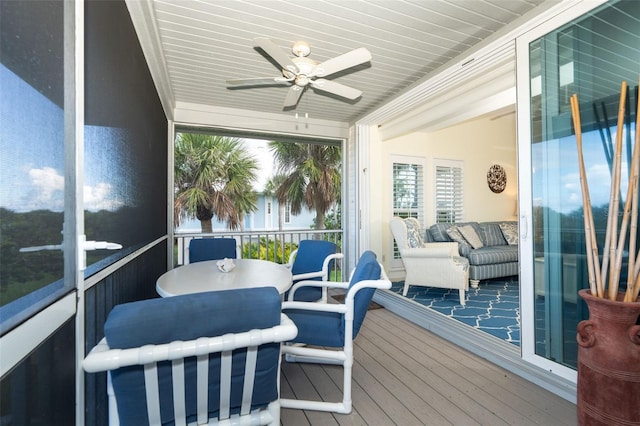 sunroom featuring ceiling fan