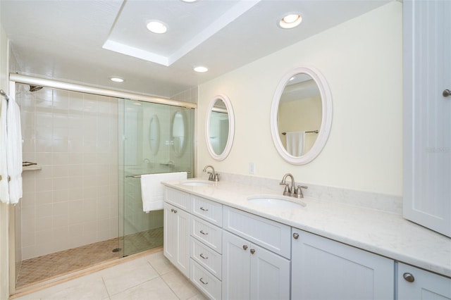 bathroom with vanity, tile patterned floors, and a shower with door