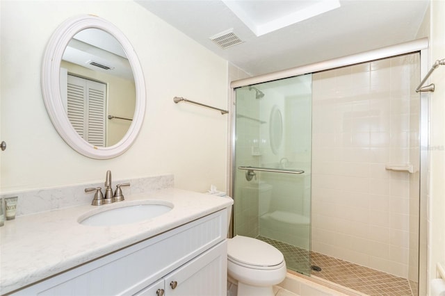 bathroom with vanity, toilet, and walk in shower