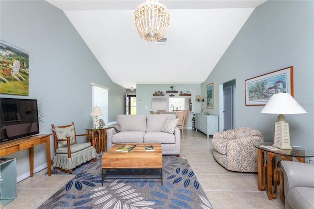 tiled living room with vaulted ceiling and a chandelier