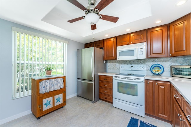 kitchen featuring ceiling fan, white appliances, light tile patterned floors, and tasteful backsplash