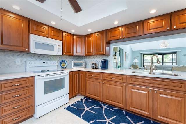 kitchen with ceiling fan, sink, tasteful backsplash, white appliances, and light tile patterned floors