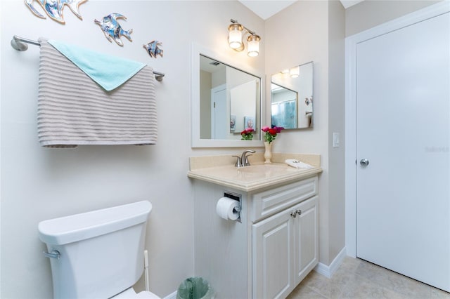 bathroom featuring tile patterned floors, vanity, and toilet