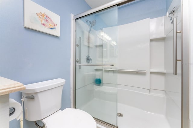 bathroom with an enclosed shower and toilet