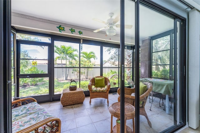 sunroom featuring ceiling fan and a healthy amount of sunlight