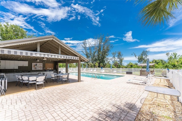 view of swimming pool with ceiling fan and a patio area