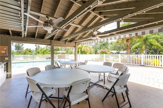 view of patio featuring a fenced in pool and ceiling fan