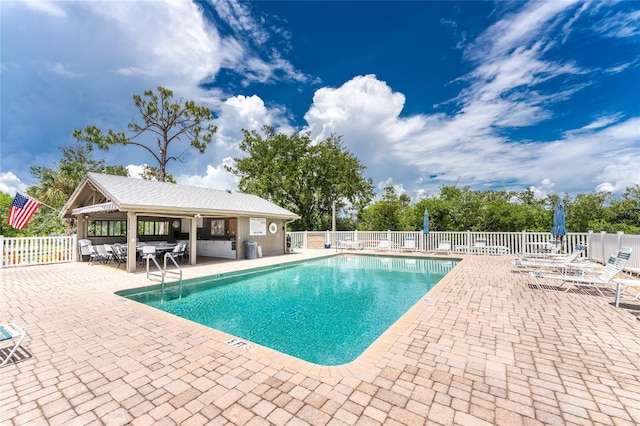 view of swimming pool with a patio