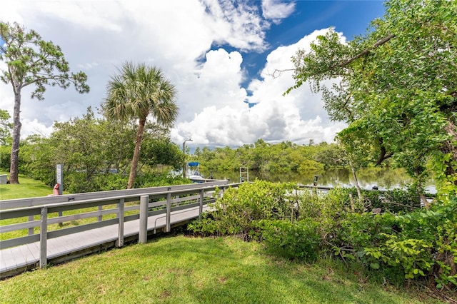 view of property's community featuring a water view and a yard