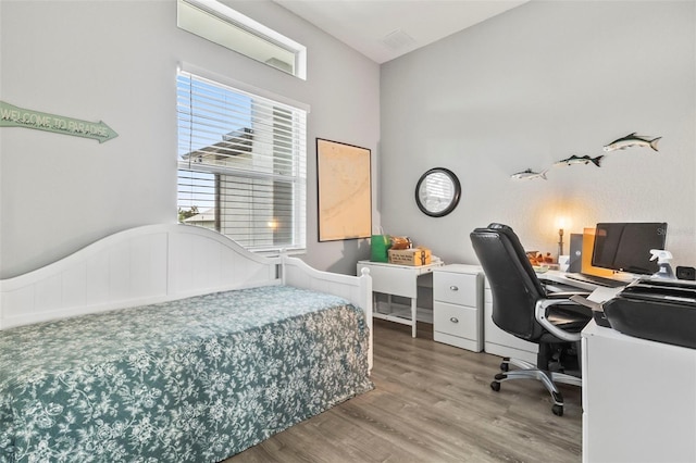 bedroom with wood-type flooring