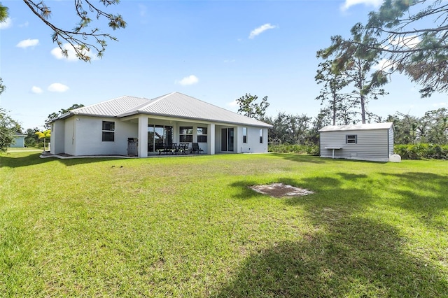 rear view of property with a lawn