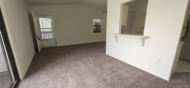 unfurnished living room with light colored carpet and lofted ceiling