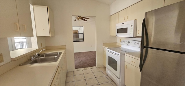 kitchen with ceiling fan, white appliances, sink, and light tile patterned floors