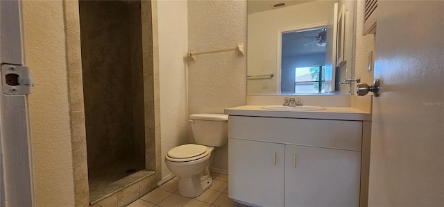 bathroom with walk in shower, tile patterned floors, toilet, and vanity