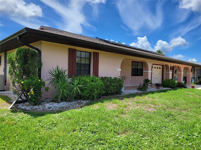 ranch-style home with a front lawn