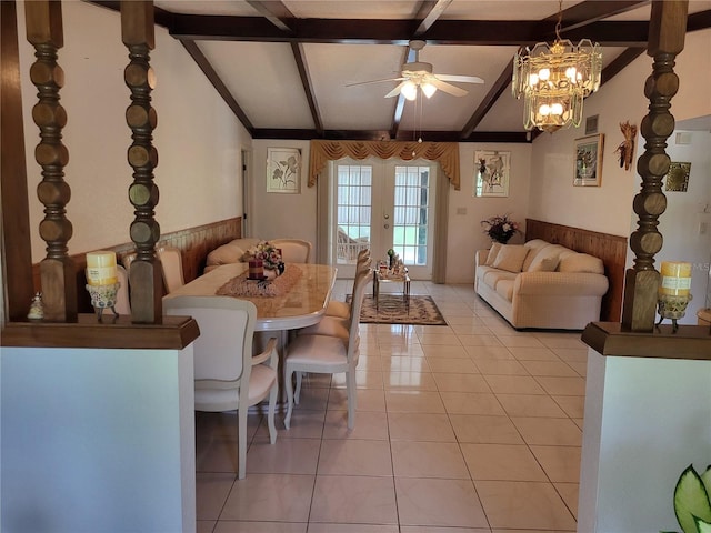 living room featuring vaulted ceiling with beams, french doors, light tile patterned flooring, and ceiling fan with notable chandelier