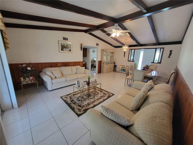 tiled living room featuring ceiling fan, wooden walls, and lofted ceiling with beams