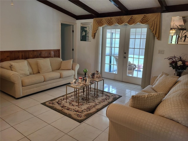 tiled living room featuring vaulted ceiling with beams and french doors