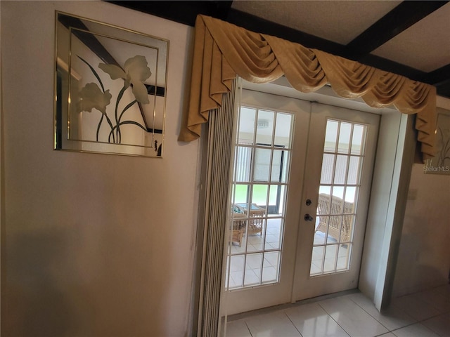 doorway with light tile patterned floors and french doors